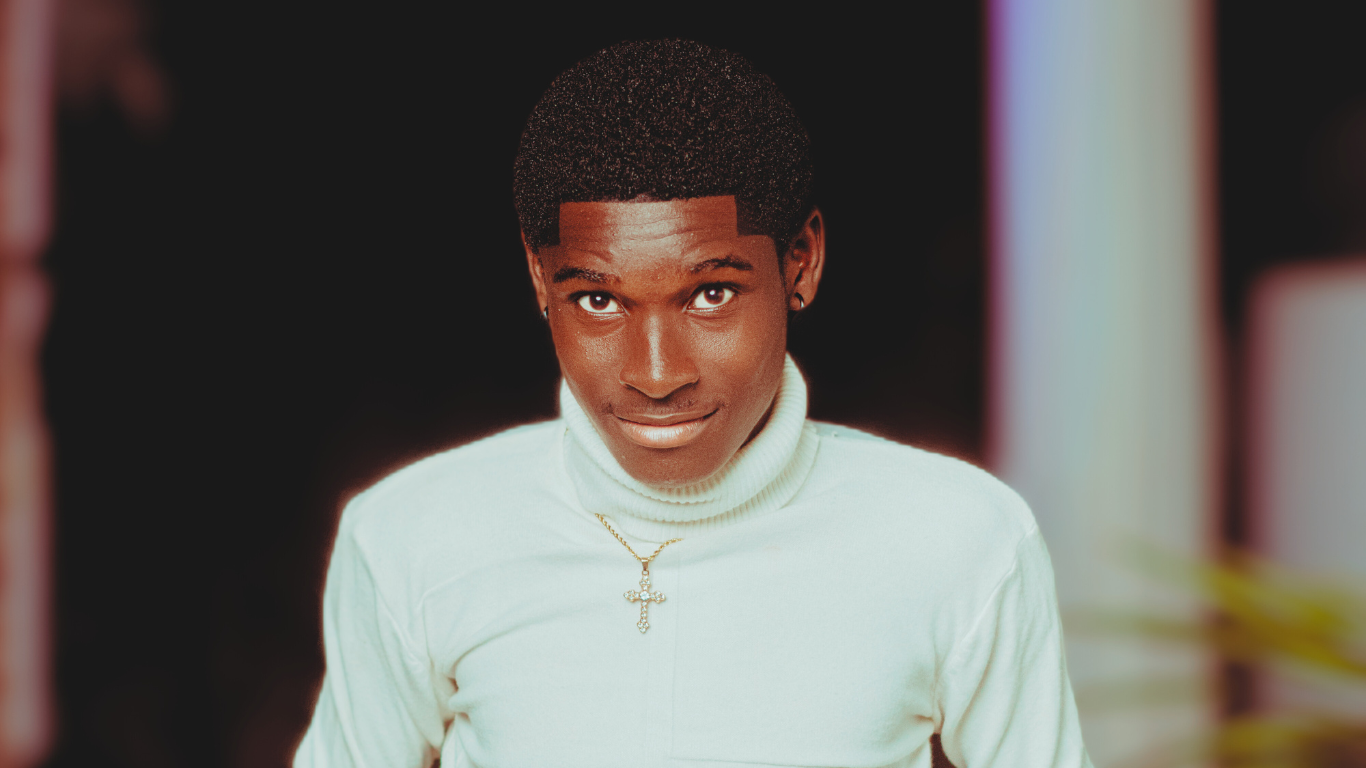 Jomasco Waves (Joseph Mensah) portrait in a white turtleneck